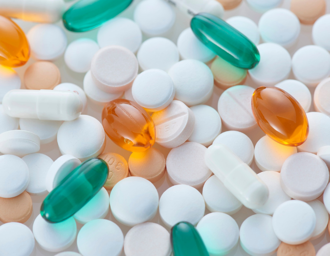 Multiple pills symbolizing how the longevity biotech and nutraceutical industry is developing new anti-aging interventions to support healthy aging and age-related diseases.